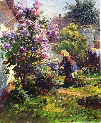 Frau im Blumengarten mit Fliederstrauch
